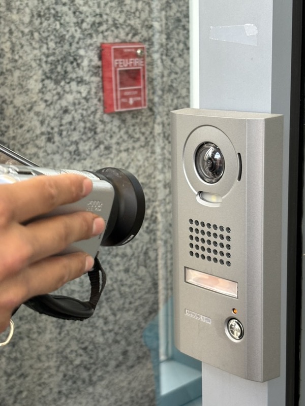 Holding a camcorder up to a security camera